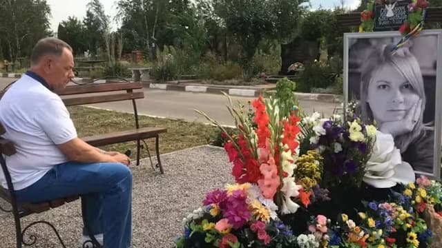 Memorial for Kateryna Handziuk with flowers and her portrait, photo from BBC story about the Ukrainian activist's murder https://www.bbc.com/ukrainian/features-russian-49150782